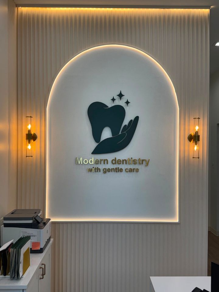 Illuminated Modern Dentistry with Gentle Care logo wall at LeesPike Dental