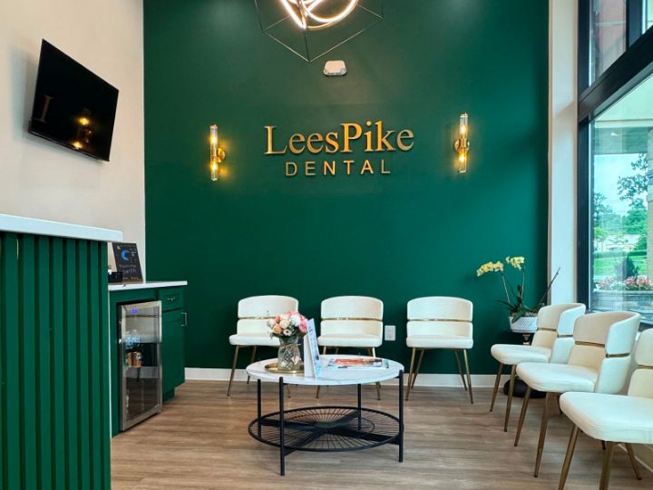 LeesPike Dental gold logo on green brand wall in the Sterling lobby